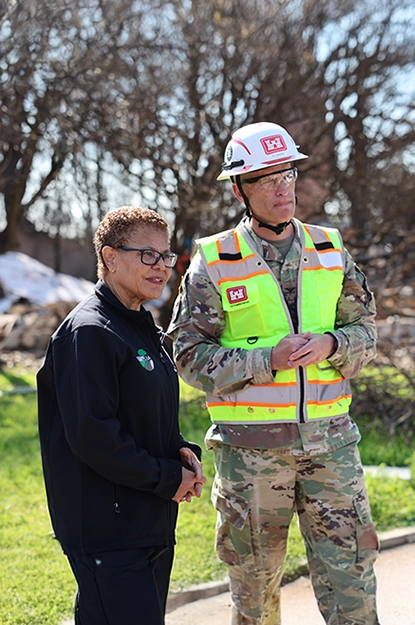 Mayor Bass and person standing and staring