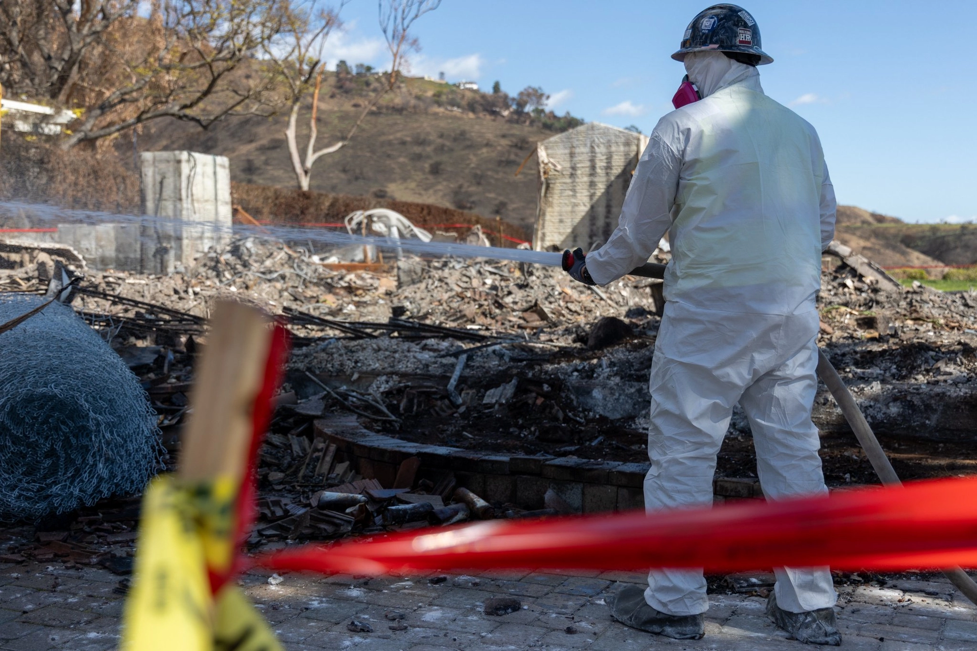 City worker in protective gear cleaning debris